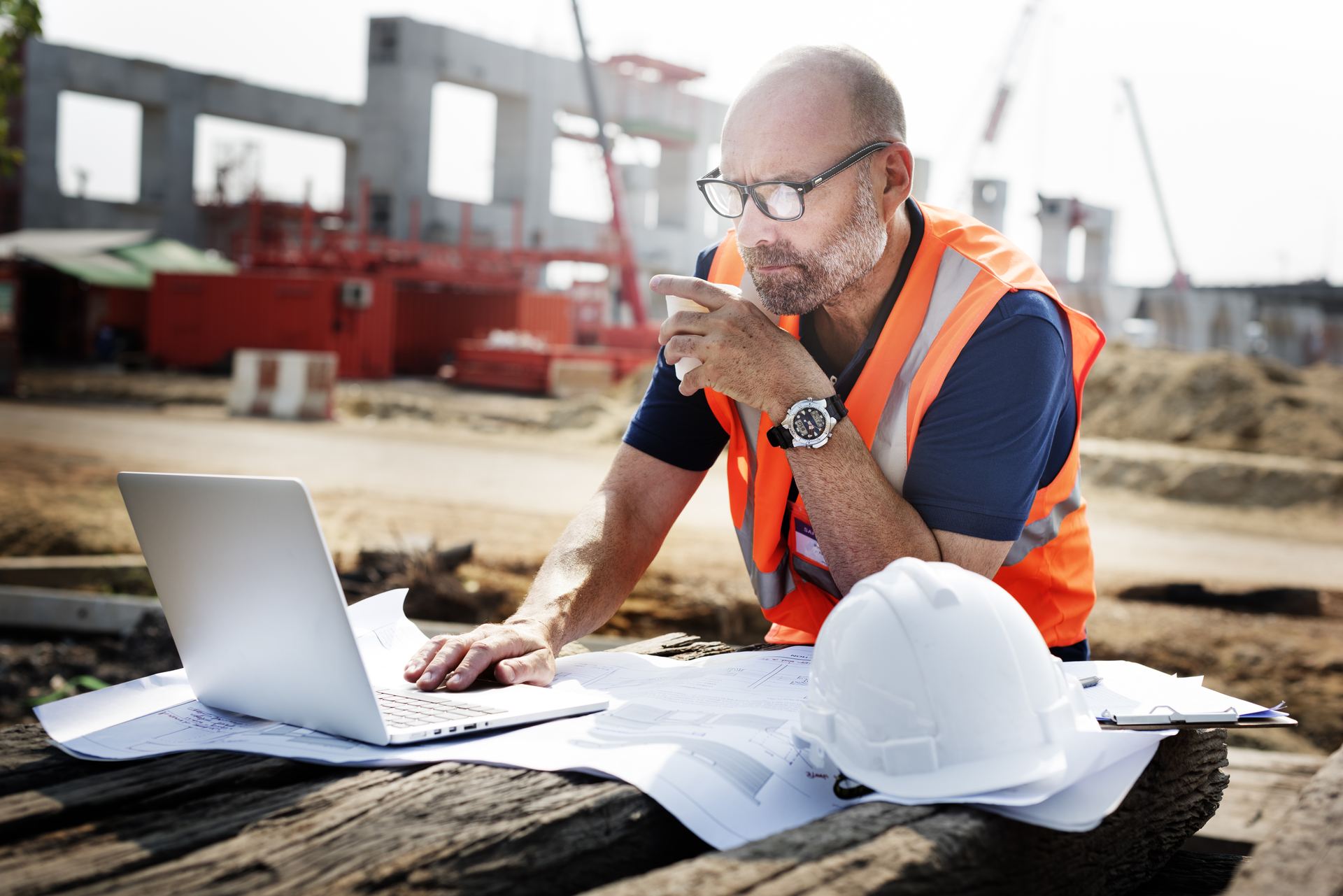 Project managers reviewing plans at a construction site